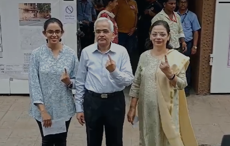 RBI Governor, Shaktikanta Das and his family pose with inked fingers after voting in Mumbai.